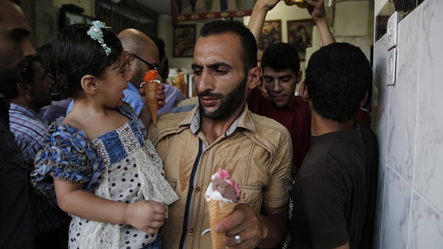 Palestinians crowd into an ice cream shop during the first day of a three day ceasefire, in Gaza City August 5, 2014.  Israel withdrew ground forces from the Gaza Strip on Tuesday and started a 72-hour ceasefire with Hamas mediated by Egypt as a first step towards negotiations on a more enduring end to the month-old war. Gaza officials say the war has killed 1,834 Palestinians, most of them civilians. Israel says 64 of its soldiers and three civilians have been killed since fighting began on July 8, after a