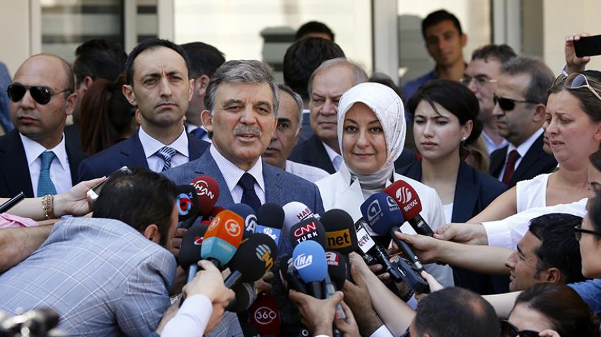 Turkey's incumbent President Abdullah Gul and his wife Hayrunnisa Gul talk to the media as they leave a polling station after casting their votes in Ankara August 10, 2014. Turks began voting on Sunday with Tayyip Erdogan poised to become the country's first elected president, fulfilling his dream of what he calls a "new Turkey" and his opponents say will be an increasingly authoritarian nation. REUTERS/Umit Bektas (TURKEY - Tags: POLITICS ELECTIONS) - RTR41UXL