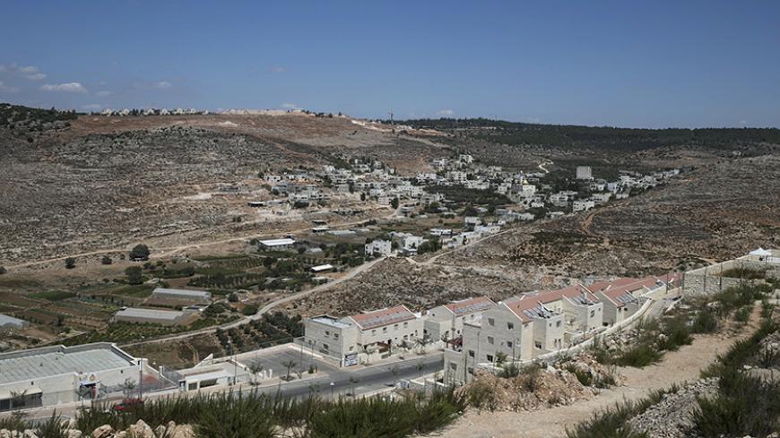 A view of Wadi Fukin is seen from the Jewish settlement of Beitar Illit (front), near the West Bank town of Bethlehem September 10, 2014. Days after a ceasefire was reached in the war in Gaza last month, Israel announced that 400 hectares (988 acres) west of Bethlehem, in the occupied West Bank, was now "state land" - that is territory for Israel, not land that will be part of any future Palestinian state. Picture taken September 10, 2014. REUTERS/Baz Ratner (WEST BANK - Tags: POLITICS) - RTR45RRL