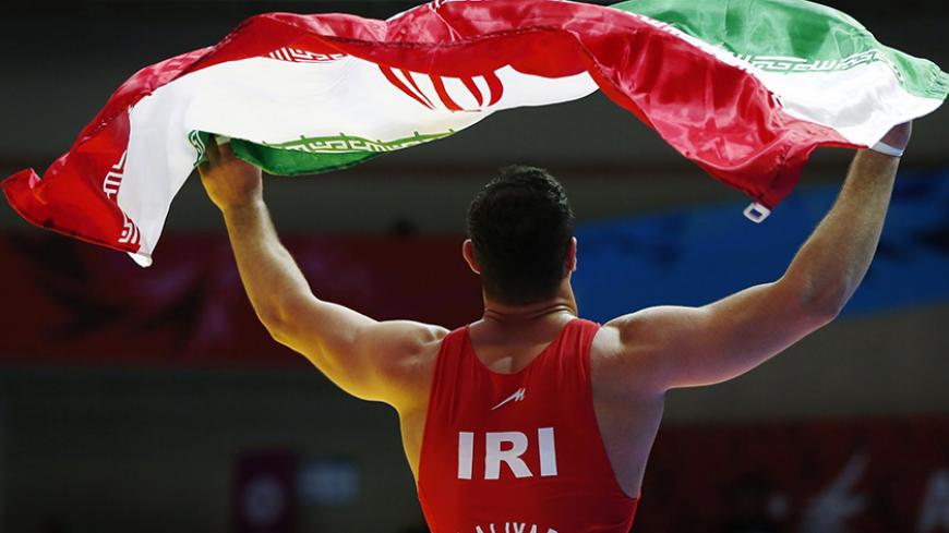 Iran's Mahdi Aliyarifeizabadi celebrates beating China's Xiao Di in their men's Greco-Roman 98 kg gold medal wrestling match at Dowon Gymnasium during the 2014 Asian Games in Incheon September 30, 2014. REUTERS/Issei Kato   (SOUTH KOREA - Tags: SPORT WRESTLING) - RTR48BNP