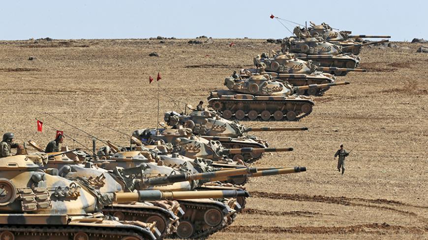 Turkish army tanks take up position on the Turkish-Syrian border near the southeastern town of Suruc in Sanliurfa province October 6, 2014. Outgunned Kurdish fighters vowed on Monday not to abandon their increasingly desperate efforts to defend the Syrian border town of Kobani from Islamic State militants pressing in from three sides and pounding them with heavy artillery. Despite the heavy fighting, which has seen mortars rain down on residential areas in Kobani and stray fire hit Turkish territory, a Reut