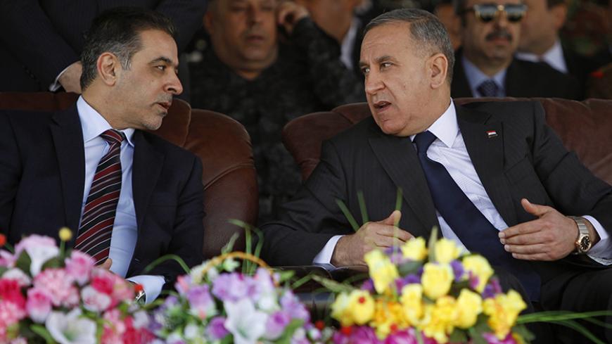 Iraqi Interior Minister Mohammed Salem al-Ghabban (L) and Iraq's Defence Minister Khaled al-Obeidi (R) attend a ceremony marking the Iraqi Police Day's 93rd anniversary at a police academy in Baghdad January 8, 2015. REUTERS/Ahmed Saad (IRAQ - Tags: CIVIL UNREST MILITARY ANNIVERSARY LAW) - RTR4KL0R