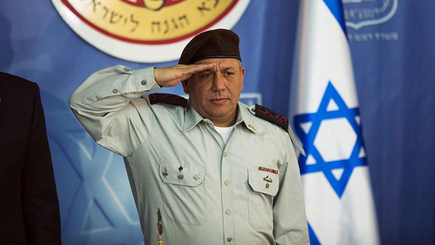 The new Israeli Chief of Staff Lieutenant-General Gadi Eizenkot salutes during a handover ceremony at the prime minister's office in Jerusalem, in which he replaced Lieutenant-General Benny Gantz, February 16, 2015. REUTERS/Ronen Zvulun (JERUSALEM - Tags: POLITICS MILITARY) - RTR4PRM7