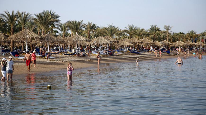 Tourists enjoy the water at a beach at the Red Sea resort of Sharm el-Sheikh city, which is hosting the Arab Summit on Saturday, in the South Sinai governorate, south of Cairo March 27, 2015. REUTERS/Amr Abdallah Dalsh  - RTR4V7SB