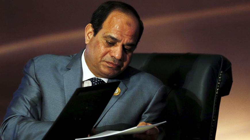 Egyptian President Abdel Fattah al-Sisi attends reads documents before the start of closing session of the Arab Summit in Sharm el-Sheikh, in the South Sinai governorate, south of Cairo, March 29, 2015. Arab leaders at a summit in Egypt will announce the formation of a unified regional force to counter growing security threats, according to a draft of the final communique, as conflicts rage from Yemen to Libya. REUTERS/Amr Abdallah Dalsh  - RTR4VBYN
