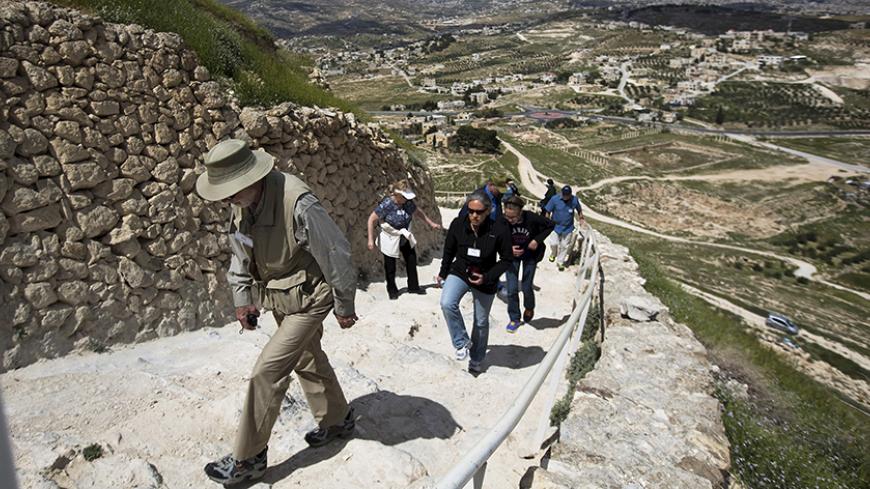 Tourists visit Herodium, where Herod's fortress palace once stood, south of the West Bank city of Bethlehem March 31, 2015. Israeli archaeologists have recently uncovered a grand arched walkway built by Herod the Great at his palace of Herodium that sheds more light on the formidable building projects of the Jewish Roman king. After the palace-fort was completed, Herod appears to have changed his mind and he ordered the entire mound, including the walkway, to be buried under rubble and it remained hidden un