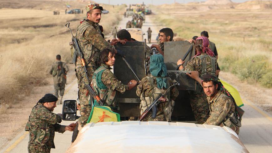 A convoy of Kurdish People's Protection Units (YPG) fighters enter the village of Tel Khanzir, after they took control of the area from Islamic State fighters, in the western countryside of Ras al-Ain May 28, 2015. The YPG, supported by U.S.-led air strikes, have been making steady gains this month against Islamic State in the northeast, which is important in the battle against the jihadists due to its location bordering territory held by the group in Iraq. Picture taken May 28, 2015. REUTERS/Rodi Said     