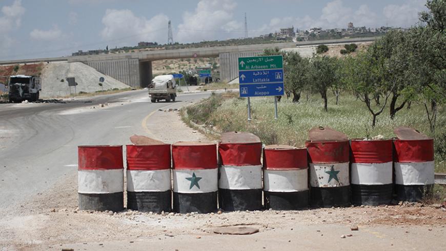 A view shows a checkpoint used by forces loyal to Syria's President Bashar al-Assad in the northwestern city of Ariha, after a coalition of insurgent groups seized the area in Idlib province May 29, 2015. Insurgents who captured the last government-held town in Syria's Idlib province celebrated inside on Friday and made more advances in surrounding areas, in a further blow to the stretched army and allied militia. REUTERS/Abed Kontar - RTR4Y2JU