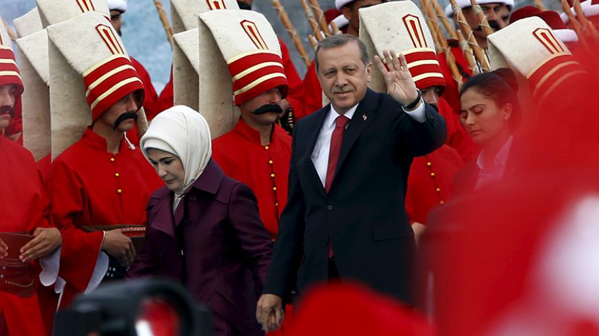 Turkish President Tayyip Erdogan, accompanied by his wife Emine Erdogan (L), greets his supporters as he arrives at the a ceremony to mark the 562nd anniversary of the conquest of the city by the Ottoman Turks, in Istanbul, Turkey, May 30, 2015. REUTERS/Murad Sezer  - RTR4Y59A