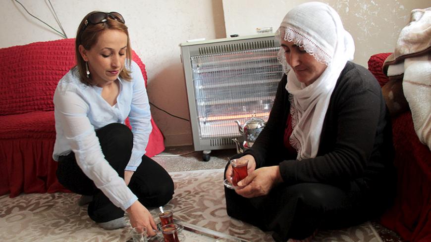 Nezahat Eleftos (R) chats with her daughter Leyla at her home in Diyarbakir, in the Kurdish-dominated southeastern Turkey, April 20, 2015. For nearly four decades, Eleftos tried to guard her grandmother Zarife's secret that she too had been born a Christian Armenian - and not a Muslim Kurd like all her neighbors in Onbasilar, a village set in the rocky hills of Turkey's Diyarbakir province. A century after the killing of Zarife's brothers and hundreds of thousands of other Armenians in Ottoman Turkish lands