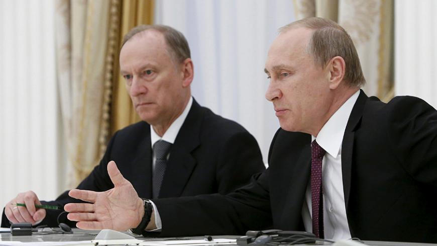 Russian President Vladimir Putin (R), accompanied by Security Council Secretary Nikolai Patrushev, attends a meeting with the BRICS countries' senior officials in charge of security matters at the Kremlin in Moscow, Russia, May 26, 2015. REUTERS/Sergei Karpukhin - RTX1EM1D