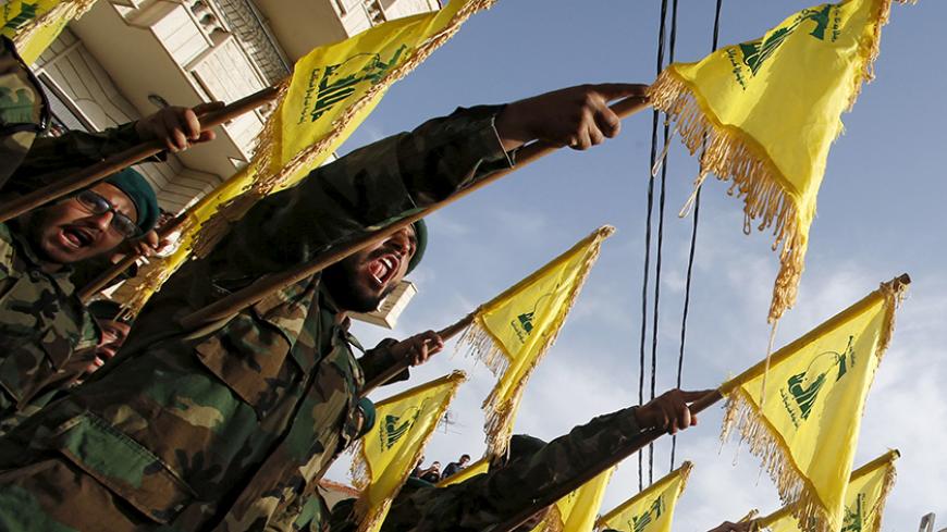 Lebanon's Hezbollah members carry Hezbollah flags during the funeral of their fellow fighter Adnan Siblini, who was killed while fighting against insurgents in the Qalamoun region, in al-Ghaziyeh village, southern Lebanon May 26, 2015. Hezbollah is fighting across all of Syria alongside the army of Syria's President Bashar al-Assad and is willing to increase its presence there when needed, the leader of the Lebanese Shi'ite movement said on Sunday. REUTERS/Ali Hashisho - RTX1EN4E
