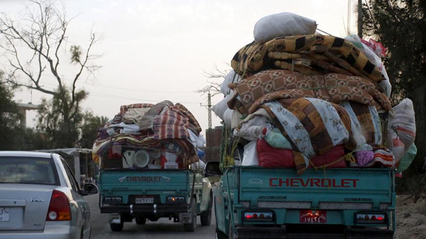 Pickup trucks filled with personal belongings, leave the border areas in northern Sinai, where authorities are battling insurgents on the high way between Al-Arish and the border town of Rafah, Egypt, May 25, 2015. Authorities in the Sinai Peninsula are battling insurgents who support Islamic State, the militant group that has seized parts of Iraq, Syria and Libya. The Sinai conflict, which has has displaced hundreds of Egyptians, is the biggest security challenge for President Abdel Fattah al-Sisi, who has