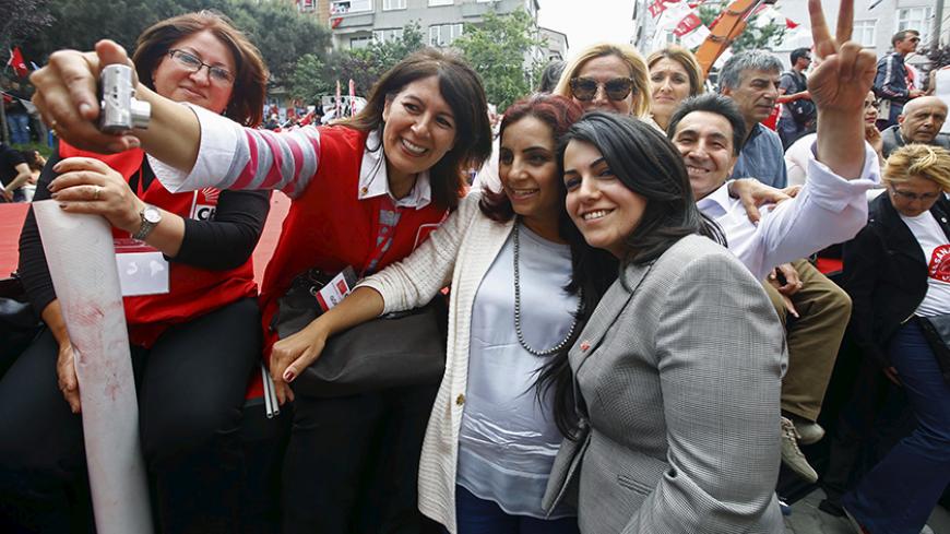 Selina Dogan Ozuzun (2nd R), an Armenian candidate for the main opposition Republican People's Party (CHP), poses with her supporters during an election rally for Turkey's June 7 parliamentary election, in Istanbul, Turkey, June 2, 2015. Candidates from the lesbian, gay, bisexual and transgender community - along with Christians, Roma and members of dozens of other ethnicities and cultures - are running for parliament this weekend in large numbers for the first time. In a country that once viewed its divers