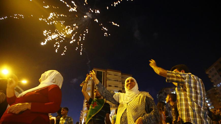 Fireworks explode as supporters of the pro-Kurdish Peoples' Democratic Party (HDP) celebrate along a street after the parliamentary election in Diyarbakir, Turkey, June 7, 2015. Partial results from Turkey's parliamentary election on Sunday put the ruling AK Party on 43.6 percent of the vote, with just under two-thirds of ballots counted, a level which could leave it struggling to form a single-party government. The results, broadcast by CNN Turk, put the pro-Kurdish Peoples' Democratic Party (HDP) at 10.6 