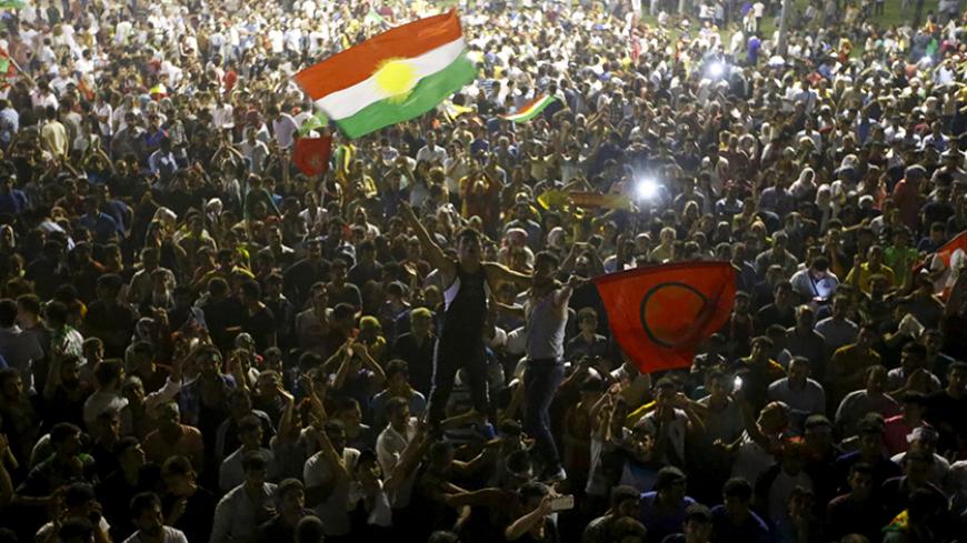 Supporters celebrate outside the pro-Kurdish Peoples' Democratic Party (HDP) headquarters in Diyarbakir, Turkey, June 7, 2015. Thousands of jubilant Kurds flooded the streets of Turkey's southeastern city of Diyarbakir on Sunday, setting off fireworks and waving flags as the pro-Kurdish opposition looked likely to enter parliament as a party for the first time. REUTERS/Osman Orsal - RTX1FJRA