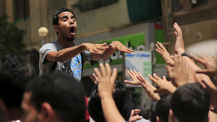 A supporter of the Muslim Brotherhood and deposed Egyptian President Mohamed Mursi shouts slogans against an Egyptian court's decision to sentence Mursi and other leaders to death, at a rally in Al Haram street near Giza square, south of Cairo, Egypt June 19, 2015. Mursi will appeal against a conviction for violence, kidnapping and torture imposed by a court over the killing of protesters, his lawyers were quoted as saying by state media on Thursday. REUTERS/Amr Abdallah Dalsh - RTX1H9EE