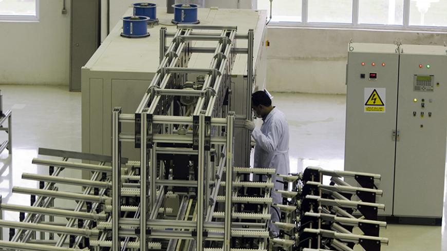 A worker works at the Fuel Manufacturing plant at Isfahan Uranium Conversion Facility 440 km (273 miles) south of Tehran April 9, 2009.   REUTERS/Caren Firouz  (IRAN POLITICS ENERGY) - RTXDTQ0