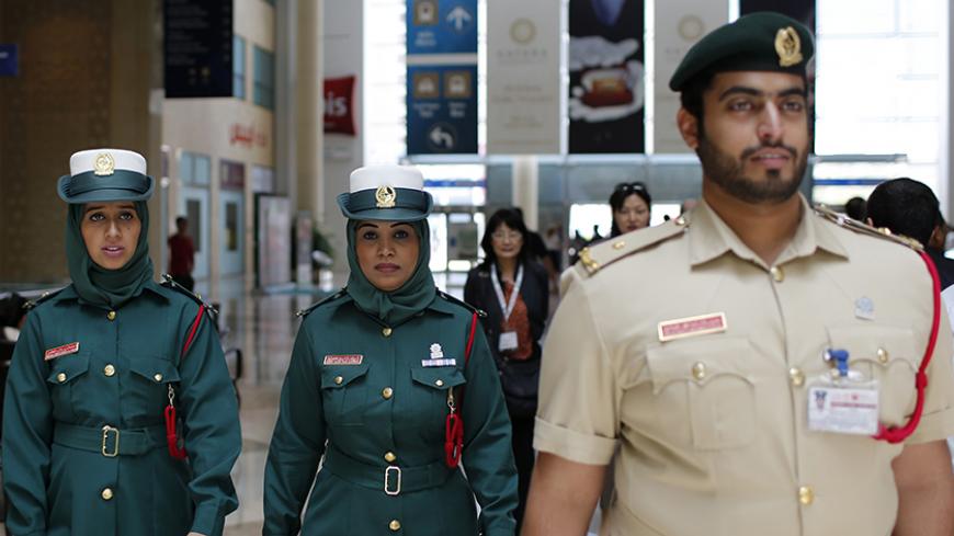 Police officers walk during the Arabian Travel Market exhibition in Dubai May 6, 2013. REUTERS/Ahmed Jadallah (UNITED ARAB EMIRATES - Tags: CRIME LAW TRAVEL BUSINESS) - RTXZCAO