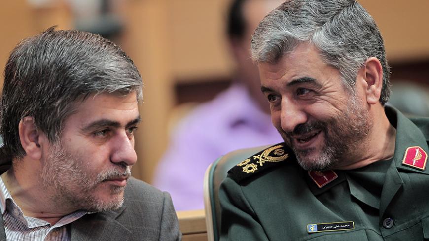 Iran's Revolutionary Guards commander General Mohammad Ali Jafari (R) chats with the head of the Iranian Atomic Energy Organization Fereydoun Abbasi Davani (L) during a ceremony in Tehran on September 6, 2011. Abbasi Davani said on Monday that Iran is ready to give the International Atomic Energy Agency "full supervision" of its nuclear programme for five years if UN sanctions are lifted. AFP PHOTO/BEHROUZ MEHRI (Photo credit should read BEHROUZ MEHRI/AFP/Getty Images)