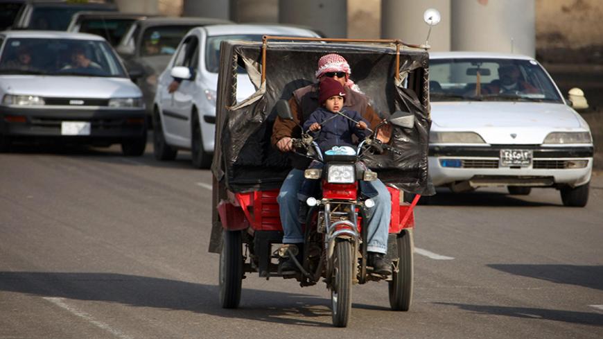 An Iraqi man and a child ride a small motorcycle through the streets of Baghdad on February 20, 2008. Moqtada al-Sadr's six-month freeze on attacks by his Mahdi Army has strengthened his hand and allowed him to purge dissidents from the ranks of the militia, analysts and aides of the Shiite cleric said. Sadr, long a thorn in the side of US-led forces in Iraq, is expected to announce on February 22, 2008 whether he will renew his unilateral ceasefire, set to expire the day after. AFP PHOTO/PATRICK BAZ (Photo