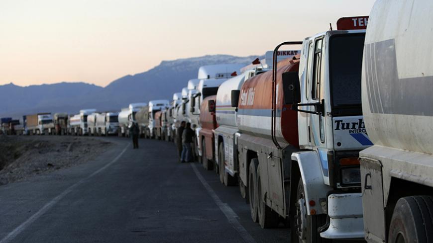 Turkish trucks and tankers, shuttling between Turkey and Iraq, queue on a road leading to the Habur border gate in southeastern Turkey, before crossing into Iraq with their goods, February 23, 2008. Turkey's exports to Iraq jumped nine percent last year to $2.8 billion and its influence can be felt across northern Iraq in the form of supermarkets, consumer goods, construction firms and traders from all over Turkey. To match feature TURKEY-IRAQ/CONFLICT REUTERS/Fatih Saribas  (TURKEY)  REUTERS/Fatih Saribas 