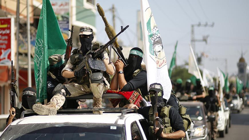 Hamas militants take part in a march through the streets of Gaza City, marking the anniversary of a prisoner swap deal between Israel and Hamas, October 18, 2012. Last year, Israel freed more than 1,000 jailed Palestinians in a swap for Gilad Shalit, an Israeli soldier held in Gaza. REUTERS/Mohammed Salem (GAZA - Tags: POLITICS CIVIL UNREST ANNIVERSARY) - RTR39A0Z