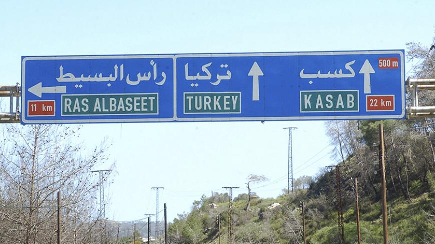 A road sign shows the direction to the Armenian Christian town of Kasab in Syria's Latakia region on the Mediterranean coast, March 31, 2014, in this handout released by Syria's national news agency SANA. Three mortar rounds landed on Turkish soil, fired during fighting between the Islamist rebels in Syria and forces loyal to Syrian President Bashar al-Assad for control of the Armenian Christian village of Kasab, Turkey's Dogan News Agency said. Islamist insurgents launched an offensive about ten days ago i