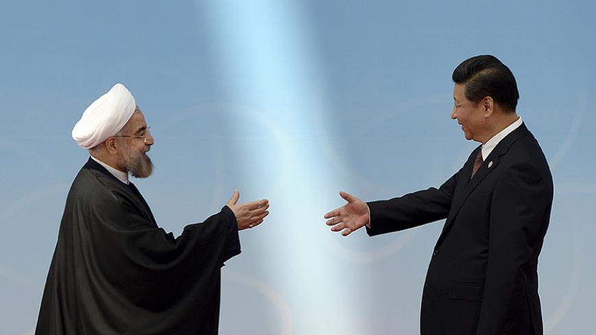 Iran's President Hassan Rouhani (L) shakes hands with his Chinese counterpart Xi Jinping before the opening ceremony of the fourth Conference on Interaction and Confidence Building Measures in Asia (CICA) summit in Shanghai May 21, 2014. REUTERS/Mark Ralston/Pool (CHINA - Tags: POLITICS) - RTR3Q3X0