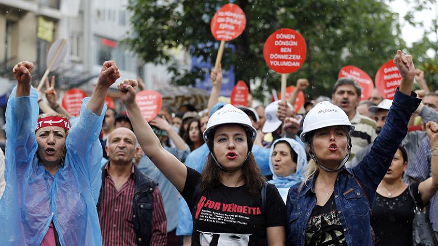 Alevi demonstrators shout anti-goverment slogans during a protest against the latest violence in Okmeydani, a working-class district in the center of the city, in Istanbul May 25, 2014. Two people died last week after clashes between Turkish police and protesters in Okmeydani, a working-class district of Istanbul, stirring fears of further unrest as the anniversary of last year's anti-government demonstrations approaches. Okmeydani is home to a community of Alevis, a religious minority in mainly Sunni Musli