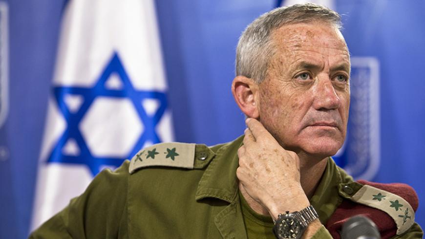 Israeli military chief Lieutenant-General Benny Gantz attends a news conference in Tel Aviv July 28, 2014. Palestinian fighters slipped into an Israeli village from the Gaza Strip and fought a gun battle with troops on Monday as an unofficial truce called for the Muslim Eid al-Fitr festival disintegrated. The incident was not the only breach of the fragile truce. Eight children and two adults were killed by a blast at a park in northern Gaza and four Israelis were reported to have been killed by cross-borde