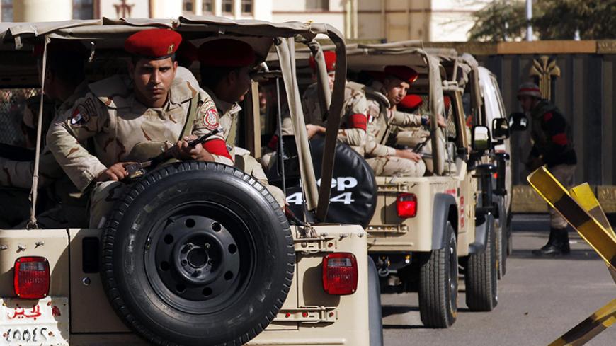 Soldiers in a convoy secure a military funeral ceremony of security personnel killed in attacks in Sinai, outside Almaza military airbase where the funerals were held, in Cairo, January 30, 2015. Islamic State's Egyptian wing has claimed the killing of at least 30 soldiers and police officers in the Sinai Peninsula. The four separate attacks on security forces in North Sinai on Thursday night were among the bloodiest in years and the first significant assault in the region since the most active Sinai milita