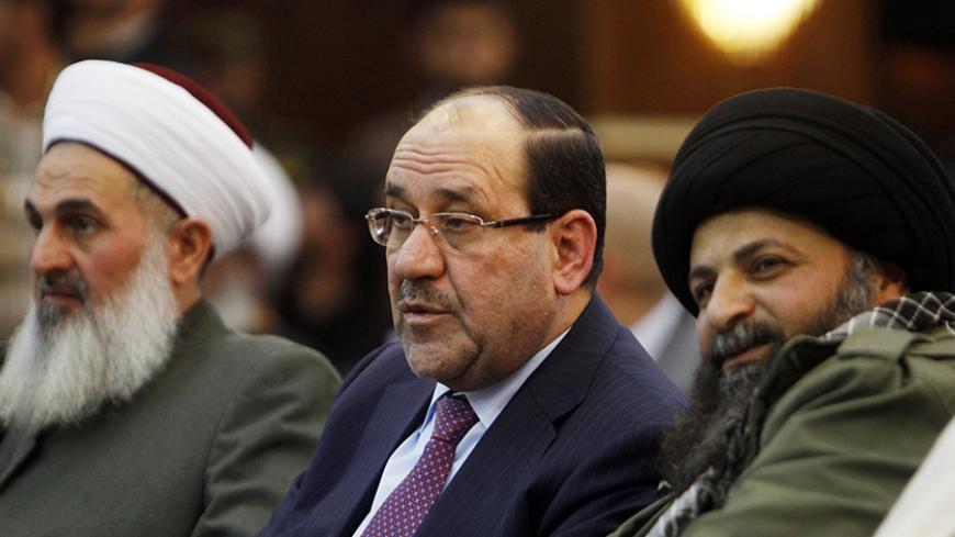 Iraqi Vice President Nuri al-Maliki (C) speaks with Hamid al-Jazaeiri (R), Deputy Commander General of Saraya al-Khorasani, at a ceremony honouring fighters of the group who died during their fight against the Islamic State, in Baghdad February 21, 2015. Families, military personnel and delegates attended the event in Baghdad to honour fighters of the Iraqi Shi'ite militia group formed in 2013 in response to Iran's Supreme Leader, Ayatollah Ali Khamenei's call to fight Sunni jihadists in Syria and later in 