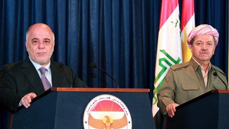 Iraqi Kurdish President Massoud Barzani (R) and Iraqi Prime Minister Haider al-Abadi attend a joint news conference in Arbil April 6, 2015. Abadi said the Baghdad government would work with Kurdish authorities to liberate the northern province of Nineveh from Islamic State militants. REUTERS/Azad Lashkari - RTR4W8W4