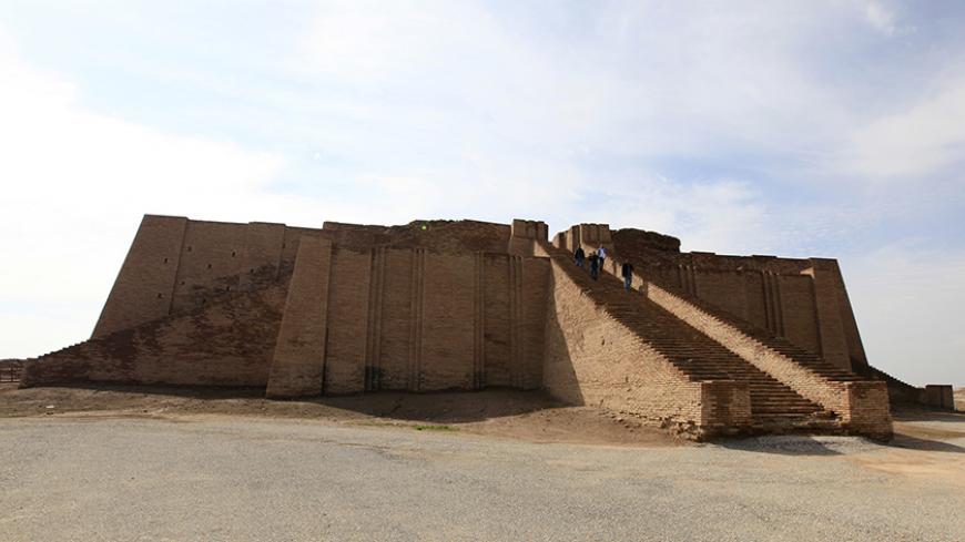 People stand on the steps of the Ziggurat of Ur ruins near Nassiriya, 300 km (186 miles) southeast of Baghdad, January 23, 2014. Ur's palaces and temples lie in ruins, but its hulking Ziggurat still dominates the desert flatlands of what is now southern Iraq, as it has for millennia. British archaeologists are now back in the area despite the insecurity in Iraq that had kept them - and all but the most adventurous tourists - away from one of the world's oldest cities. Picture taken January 23, 2014. To matc