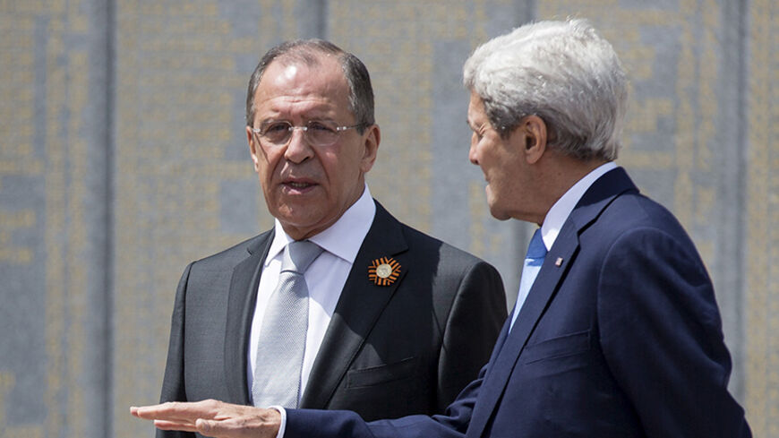 U.S. Secretary of State John Kerry (R) and Russian Foreign Minister Sergey Lavrov speak at the Zakovkzalny War Memorial in Sochi, Russia May 12, 2015.      REUTERS/Joshua Roberts - RTX1CKET