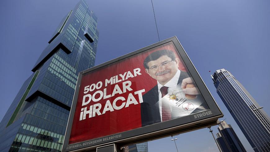 An election billboard with a picture of Turkish Prime Minister Ahmet Davutoglu and a slogan reads that: " 500 Billion Dollars Export" is pictured in Istanbul's financial district of Levent, Turkey, May 25, 2015. For the first time since coming to power in 2002, the AKP is heading into an election under fire over the economy, thanks to stalling growth, stubbornly high unemployment and worrying levels of household debt. That has given the opposition a new line of attack and highlights the difficulties a weake