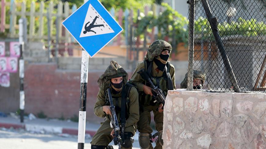 Israeli soldiers take up a position during clashes with Palestinians following a protest against Jewish settlements, in Jalazoun refugee camp, near the West Bank city of Ramallah June 12, 2015. REUTERS/Mohamad Torokman
 - RTX1G9IR