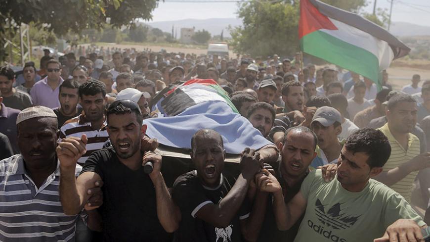 Mourners carry the body of Palestinian gunman Hamad Romaneen during his funeral near the West Bank city of Jericho June 26, 2015. Israeli soldiers shot and killed Romaneen in the occupied West Bank on Friday after he opened fire on them at a checkpoint, the Israeli military said. REUTERS/Ammar Awad TPX IMAGES OF THE DAY      - RTX1HXKK