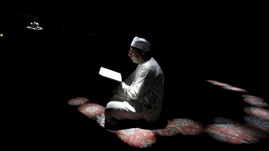A Muslim man reads the Koran during the holy month of Ramadan inside Al-Refaie mosque in the old Islamic area of Cairo, Egypt, June 28, 2015. REUTERS/Mohamed Abd El Ghany      TPX IMAGES OF THE DAY      - RTX1I4SC