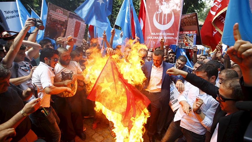 Demonstrators set fire to a Chinese flag during a protest against China near the Chinese Consulate in Istanbul, Turkey, July 5, 2015. China warned its citizens travelling in Turkey to be careful of anti-Beijing protests, warning them that some Chinese tourists have recently been "attacked and disturbed". The notice, posted on the Ministry of Foreign Affairs website on Sunday, said that there have recently been "multiple" demonstrations in Turkey targeting the Chinese government. The notice gave no details r