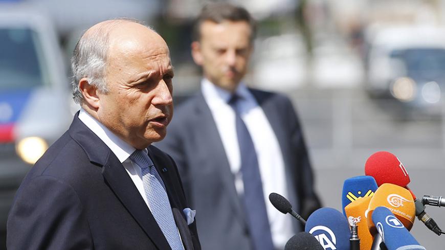 French Foreign Minister Laurent Fabius talks to journalists outside Palais Coburg, the venue for nuclear talks in Vienna, Austria, July 7, 2015. Iran and six major powers will keep negotiating past Tuesday's deadline for a long-term nuclear agreement as they tackle the most contentious issues, including the continuation of a U.N. arms embargo on Iran, the big powers said. REUTERS/Leonhard Foeger - RTX1JEIQ