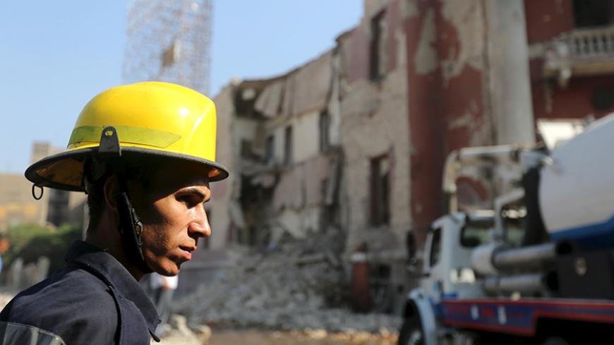 An Egyptian emergency personnel arrives at the site following a bomb blast at the Italian Consulate in Cairo, Egypt, July 11, 2015. A bomb exploded in front of the Italian consulate in Cairo on Saturday, killing one person, the health ministry and security officials said, raising the possibility that Islamist militants could open a new front against foreigners. REUTERS/Mohamed Abd El Ghany - RTX1JYUC