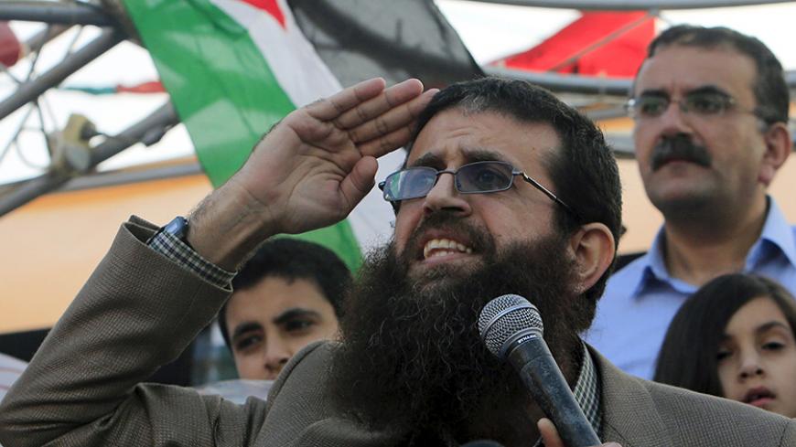 Palestinian Islamic Jihad leader Khader Adnan gestures as he speaks during a rally honoring him following his release, near the West Bank city of Jenin July 12, 2015. Israel on Sunday released Adnan from jail following a deal last month in which he agreed to end a 56-day hunger strike, Islamic Jihad sources in the West Bank said. REUTERS/Abed Omar Qusini - RTX1K3PF