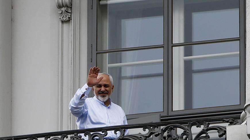 Iranian Foreign Minister Javad Zarif waves from the balcony of Palais Coburg, the venue for nuclear talks, in Vienna, Austria, July 13, 2015. Iran and six world powers appeared close to a deal on Monday to give Tehran sanctions relief in exchange for limits on its nuclear programme, but Iranian officials said talks could run past their latest midnight deadline and success was not guaranteed. REUTERS/Leonhard Foeger - RTX1K8UM