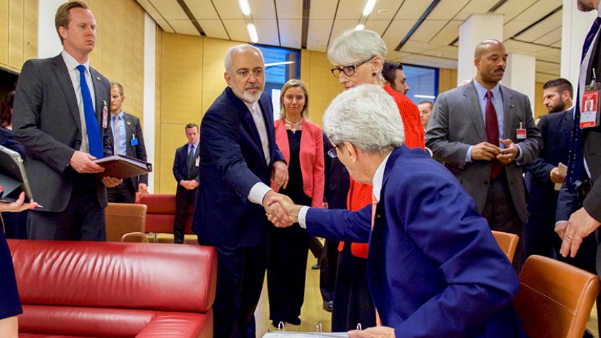 U.S. Secretary of State John Kerry (seated) shakes hands with Iranian Foreign Minister Javad Zarif as he prepares to leave the Austria Center in Vienna, Austria, July 14, 2015. Iran and six major world powers reached a nuclear deal on Tuesday, capping more than a decade of on-off negotiations with an agreement that could potentially transform the Middle East, and which Israel called an "historic surrender". REUTERS/US State Department/Handout via Reuters ATTENTION EDITORS - FOR EDITORIAL USE ONLY. NOT FOR S
