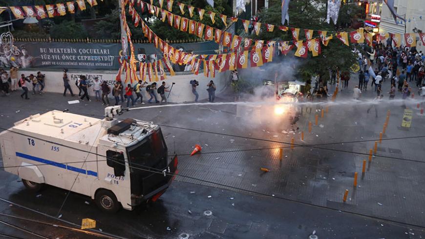 Riot police use water cannon as demonstrators throw fireworks during a protest in central Istanbul, Turkey, July 20, 2015. Police in Istanbul fired teargas and water cannon when a demonstration by protesters blaming the government for a suspected Islamic State suicide bombing turned violent, a Reuters witness said. Hundreds gathered near Istanbul's central Taksim Square after the bombing in the mostly Kurdish border town of Suruc which killed at least 30 people. Some chanted slogans against President Tayyip
