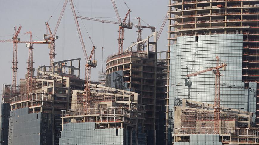 A view shows the Qatar Petroleum headquarters, which is under construction, in Doha April 8, 2013. Bankers and politicians touting their countries' wares have to work hard to get the attention of Qatar's sovereign wealth fund, such is the range of its interests, from banks to cars to soccer clubs, and its exacting requirement for returns. With estimated assets of about $200 billion, and more than a dozen potential deals on its radar every week, the state-run firm has no time for less than compelling investm