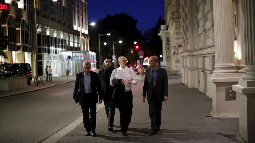 Head of the Iranian Atomic Energy Organization Ali Akbar Salehi (2nd R) walks near the hotel where the Iran nuclear talks meetings are being held in Vienna, Austria in Vienna, Austria July 4, 2015.  Iran and world powers made progress on future sanctions relief for Iran in marathon nuclear talks on Saturday, but remained divided on issues such as lifting United Nations sanctions and the development of advanced centrifuges.  REUTERS/Carlos Barria       TPX IMAGES OF THE DAY      - RTX1J12P