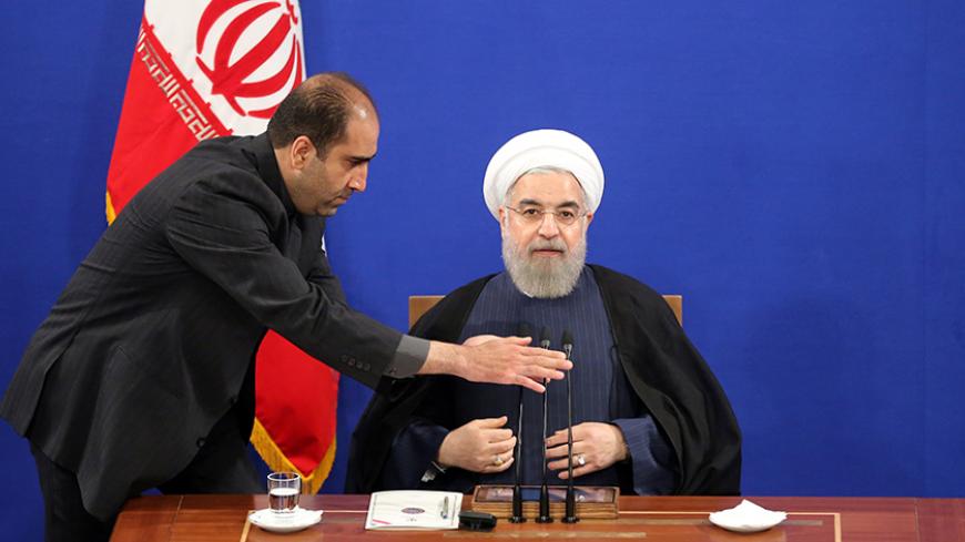 Iranian President Hassan Rouhani waits for his microphone to be adjusted to start delivering a speech during a press conference in the capital Tehran on August 29, 2015. AFP PHOTO / ATTA KENARE        (Photo credit should read ATTA KENARE/AFP/Getty Images)